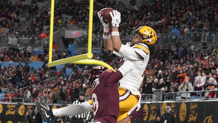 Jan 3, 2025; Charlotte, NC, USA;  Minnesota Golden Gophers wide receiver Elijah Spencer (11) makes a catch for a touchdown defended but Virginia Tech Hokies cornerback Braylon Johnson (8) during the second quarter at the Duke’s Mayo Bowl at Bank of America Stadium. Mandatory Credit: Jim Dedmon-Imagn Images