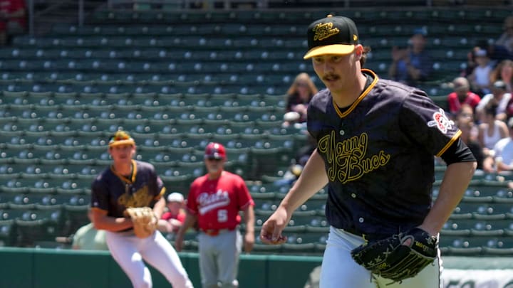 Indianapolis Indians starting pitcher Bubba Chandler goes after a ball hit by Louisville Bats outfielder Jacob Hurtubise.