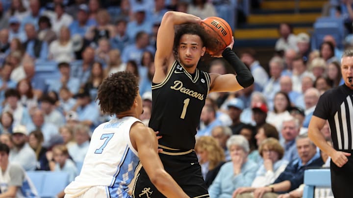 Jan 10, 2026; Chapel Hill, North Carolina, USA; Wake Forest Demon Deacons guard Nate Calmese (1) sets the play with North Carolina Tar Heels guard Seth Trimble (7) defending during the first half at Dean E. Smith Center. Mandatory Credit: Cory Knowlton-Imagn Images Jan 10, 2026; Chapel Hill, North Carolina, USA; Wake Forest Demon Deacons guard Nate Calmese (1) sets the play with North Carolina Tar Heels guard Seth Trimble (7) defending during the first half at Dean E. Smith Center. Mandatory Credit: Cory Knowlton-Imagn Images