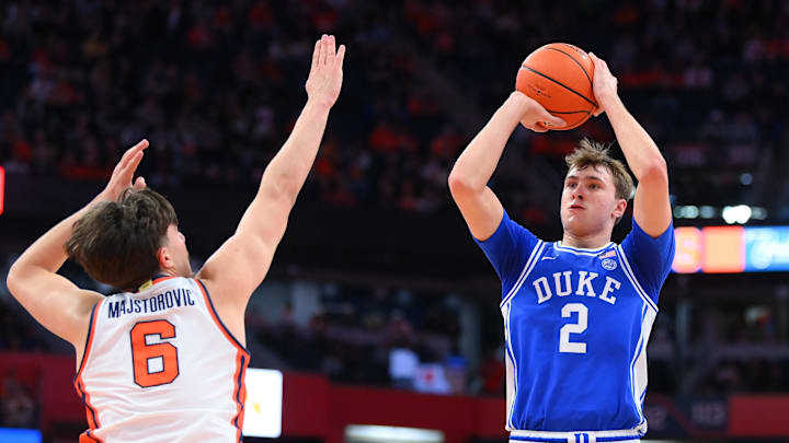 Feb 5, 2025; Syracuse, New York, USA; Duke Blue Devils guard Cooper Flagg (2) shoots against Syracuse Orange forward Petar Majstorovic (6) during the first half at the JMA Wireless Dome. Mandatory Credit: Rich Barnes-Imagn Images
