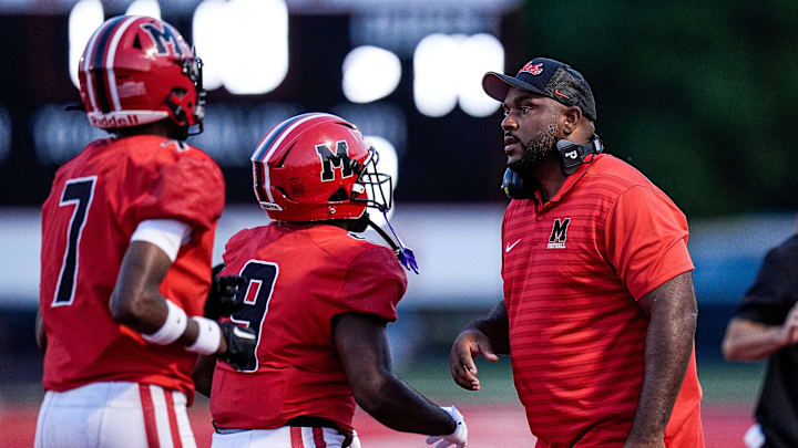 Orchard Lake St. Mary's head coach Jermaine Gonzales talks to players after a play against Warren De La Salle during the first half at Orchard Lake St. Mary's in West Bloomfield Township on Friday, September 13, 2024.
