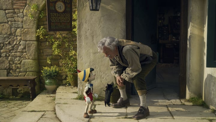 (L-R): Pinocchio (voiced by Benjamin Evan Ainsworth), Figaro, and Tom Hanks as Geppetto in Disney's live-action PINOCCHIO, exclusively on Disney+. Photo courtesy of Disney Enterprises, Inc. © 2022 Disney Enterprises, Inc. All Rights Reserved.