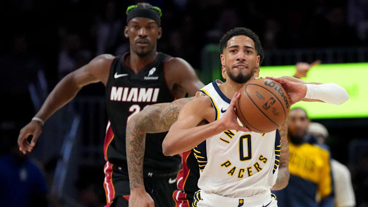 Jan 2, 2025; Miami, Florida, USA;  Indiana Pacers guard Tyrese Haliburton (0) looks to pas the ball as Miami Heat center Kel'el Ware (7) and forward Jimmy Butler (22) trail on the play during the first half at Kaseya Center. Mandatory Credit: Jim Rassol-Imagn Images