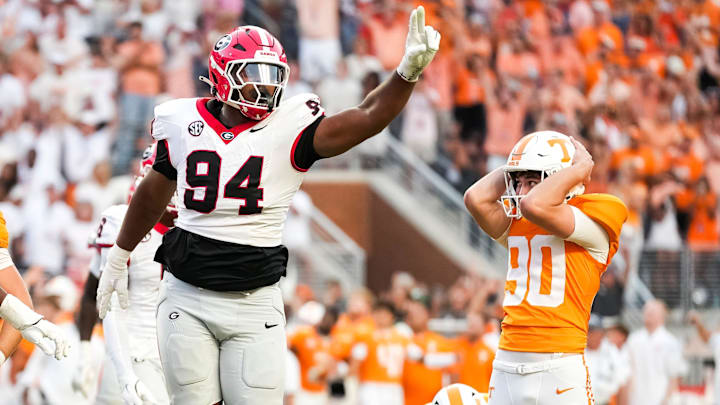 Tennessee place kicker Max Gilbert (90) holds his helmet in disbelief as Georgia defensive lineman Xzavier McLeod (94) celebrates Gilbert's missed field goal in the final seconds of a college football game between Tennessee and Georgia at Neyland Stadium in Knoxville, Tenn., on Sept. 13, 2025. Tennessee place kicker Max Gilbert (90) holds his helmet in disbelief as Georgia defensive lineman Xzavier McLeod (94) celebrates Gilbert's missed field goal in the final seconds of a college football game between Tennessee and Georgia at Neyland Stadium in Knoxville, Tenn., on Sept. 13, 2025.