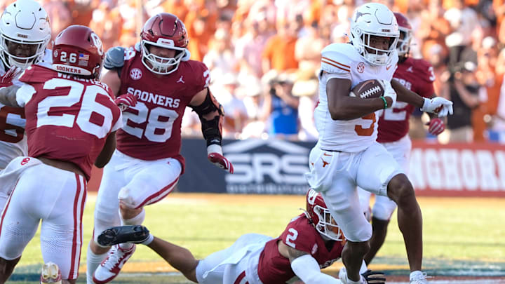Texas Longhorns wide receiver Ryan Wingo (5) leaps past Oklahoma Sooners defensive back Billy Bowman Jr. (2) and linebacker Danny Stutsman (28) during the Red River Rivalry college football game between the University of Oklahoma Sooners (OU) and the Texas Longhorns at the Cotton Bowl in Dallas, Saturday, Oct. 12, 2024. Texas one 34-3.