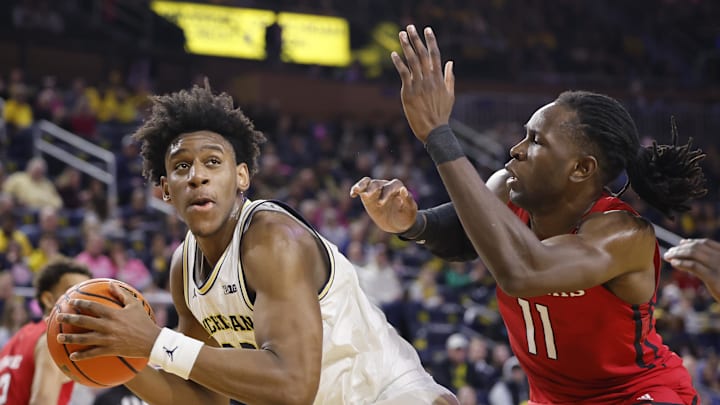 Feb 3, 2024; Ann Arbor, Michigan, USA;  Michigan Wolverines forward Tarris Reed Jr. (32) is defended