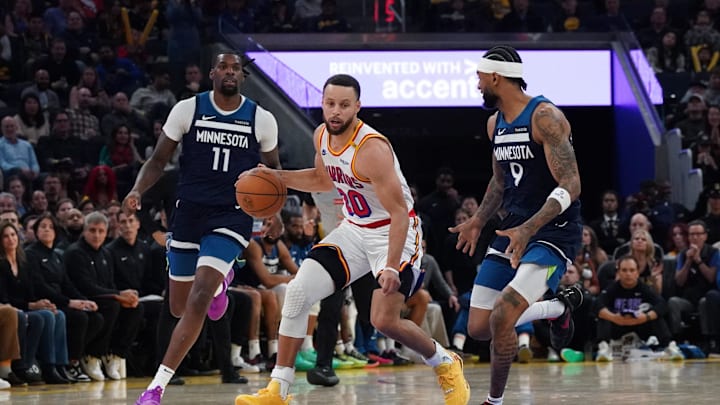 Dec 8, 2024; San Francisco, California, USA;  Golden State Warriors guard Stephen Curry (30) dribbles upcourt against Minnesota Timberwolves center-forward Naz Reid (11) and guard Nickeil Alexander-Walker (9) in the third period at Chase Center. Mandatory Credit: David Gonzales-Imagn Images