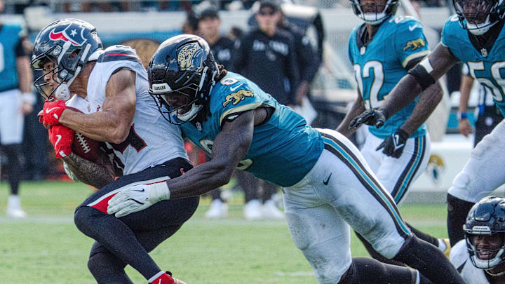 Houston Texans wide receiver Jaylin Noel (14) is tackled by Jacksonville Jaguars linebacker Devin Lloyd (0) during the fourth quarter between the Houston Texans and the Jacksonville Jaguars Sunday September 21, 2025 at EverBank Stadium in Jacksonville, Fla. The Jaguars defeated the Texans 17-10. [Doug Engle/Florida Times-Union]