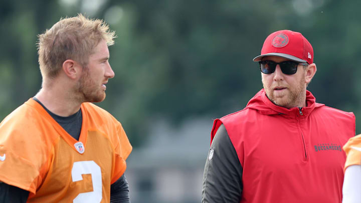 Jul 25, 2024; Tampa, FL, USA;  Tampa Bay Buccaneers offensive coordinator Liam Coen and quarterback Kyle Trask (2) during training camp at AdventHealth Training Center. 