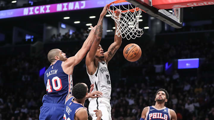 Mar 5, 2024; Brooklyn, New York, USA;  Brooklyn Nets center Nic Claxton (33) drives past Philadelphia 76ers forward Nicolas Batum (40) for a dunk in the fourth quarter at Barclays Center. Mandatory Credit: Wendell Cruz-Imagn Images