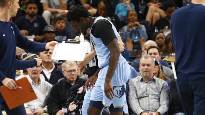 Nov 19, 2024; Memphis, Tennessee, USA; Memphis Grizzlies guard Vince Williams Jr. (5) is helped off the court during the first half against the Denver Nuggets at FedExForum. Mandatory Credit: Petre Thomas-Imagn Images