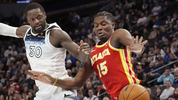 Jan 27, 2025; Minneapolis, Minnesota, USA; Minnesota Timberwolves forward Julius Randle (30) and Atlanta Hawks center Clint Capela (15) watch as a ball gets away from both of them in the fourth quarter at Target Center. Mandatory Credit: Bruce Kluckhohn-Imagn Images