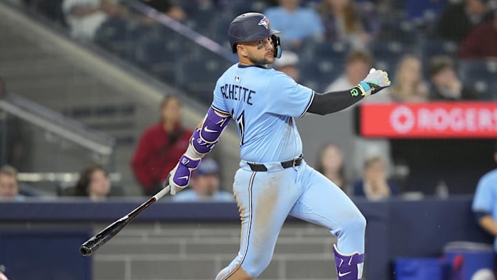 Apr 1, 2025; Toronto, Ontario, CAN; Toronto Blue Jays shortstop Bo Bichette (11) hits a two-run single against the Washington Nationals during the eighth inning at Rogers Centre.