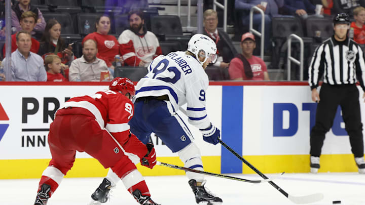 Oct 3, 2024; Detroit, Michigan, USA;  Toronto Maple Leafs left wing Alex Nylander (92) skates with the puck defended by Detroit Red Wings right wing Alex DeBrincat (93) in the third period at Little Caesars Arena. Mandatory Credit: Rick Osentoski-Imagn Images