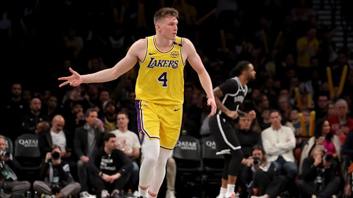 Mar 10, 2025; Brooklyn, New York, USA; Los Angeles Lakers guard Dalton Knecht (4) celebrates his three point shot against the Brooklyn Nets during the third quarter at Barclays Center. Mandatory Credit: Brad Penner-Imagn Images