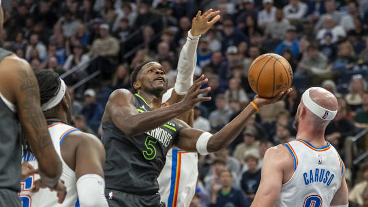 Feb 23, 2025; Minneapolis, Minnesota, USA; Minnesota Timberwolves guard Anthony Edwards (5) drives to the basket and shoots the ball against the Oklahoma City Thunder in the second half at Target Center. Mandatory Credit: Jesse Johnson-Imagn Images