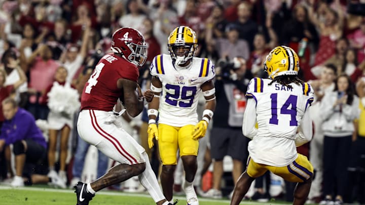 Nov 4, 2023; Tuscaloosa, Alabama, USA; Alabama Crimson Tide quarterback Jalen Milroe (4) carries the ball in for a touchdown against the LSU Tigers during the first half at Bryant-Denny Stadium. Mandatory Credit: Butch Dill-Imagn Images
