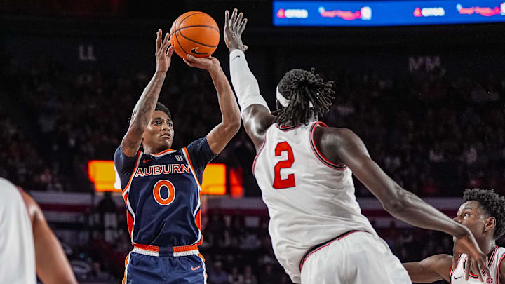 Jan 3, 2026; Athens, Georgia, USA; Auburn Tigers guard Tahaad Pettiford (0) shoots over Georgia Bulldogs center Somto Cyril (2) during the second half at Stegeman Coliseum. Mandatory Credit: Dale Zanine-Imagn Images