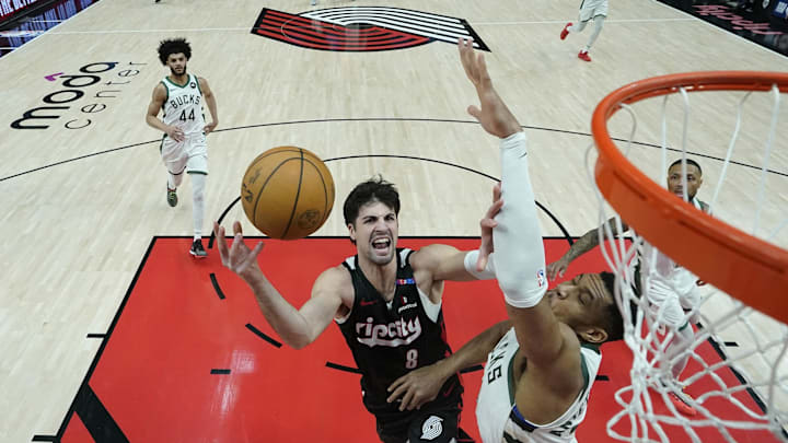 Jan 28, 2025; Portland, Oregon, USA; Portland Trail Blazers small forward Deni Avdija (8) shoots the ball against Milwaukee Bucks power forward Giannis Antetokounmpo (34) during the first half at Moda Center. Mandatory Credit: Soobum Im-Imagn Images