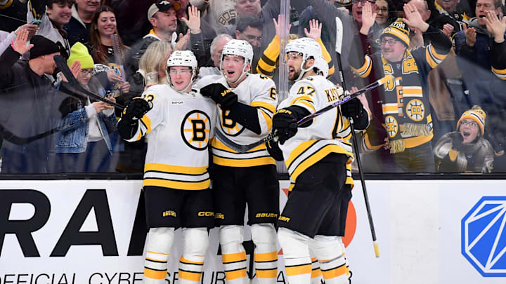 Jan 24, 2026; Boston, Massachusetts, USA; Boston Bruins center Fraser Minten (93) reacts with defenseman Mason Lohrei (6) and center Mark Kastelic (47) after scoring a goal during the third period against the Montreal Canadiens at TD Garden. Mandatory Credit: Bob DeChiara-Imagn Images