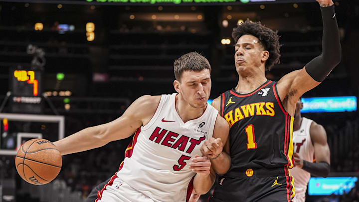 Dec 28, 2024; Atlanta, Georgia, USA; Miami Heat forward Nikola Jovic (5) dribbles defended by Atlanta Hawks forward Jalen Johnson (1) at State Farm Arena. Mandatory Credit: Dale Zanine-Imagn Images