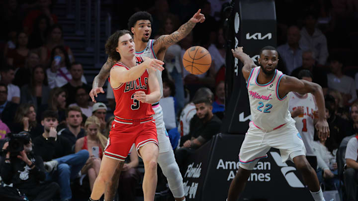 Chicago Bulls guard Josh Giddey (3) passes the ball as Miami Heat center Kel'el Ware (7) and forward Andrew Wiggins (22) defend during the third quarter at Kaseya Center. Mandatory Credit: Sam Navarro-Imagn Images