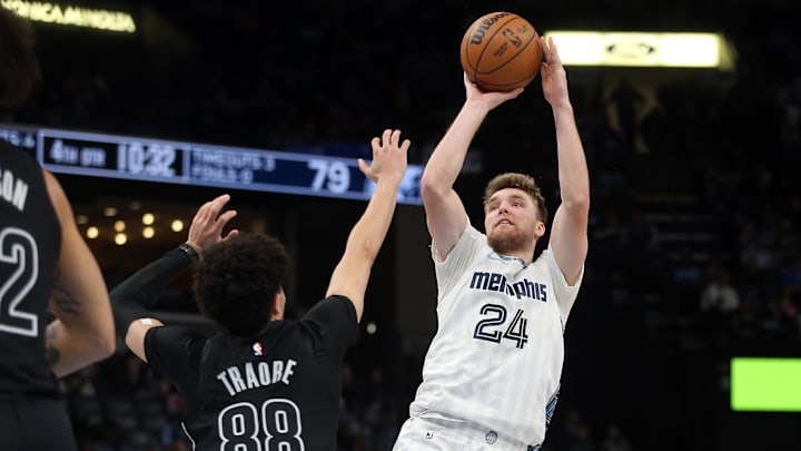 Jan 11, 2026; Memphis, Tennessee, USA; Memphis Grizzlies guard Cam Spencer (24) shoots as Brooklyn Nets guard Nolan Traore (88) defends during the fourth quarter at FedExForum. Mandatory Credit: Petre Thomas-Imagn Images