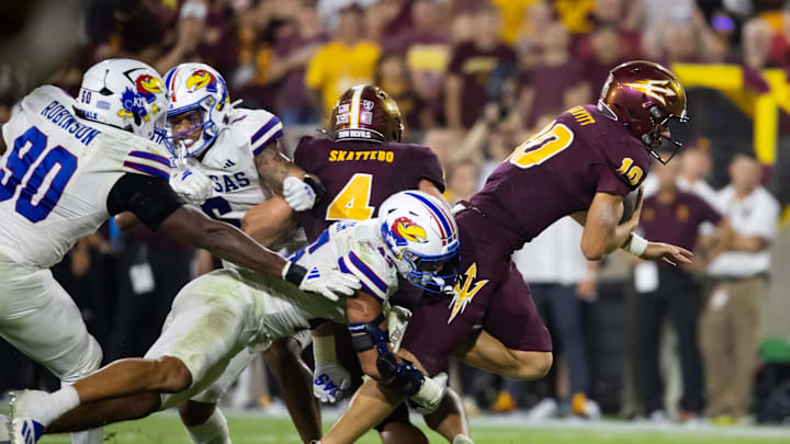 Oct 5, 2024; Tempe, Arizona, USA; Arizona State Sun Devils quarterback Sam Leavitt (10) is tackled by Kansas Jayhawks safety Devin Dye (11) in the second half at Mountain America Stadium. Mandatory Credit: Mark J. Rebilas-Imagn Images