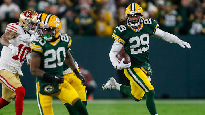 Green Bay Packers safety Xavier McKinney (29) returns an interception against the San Francisco 49ers.