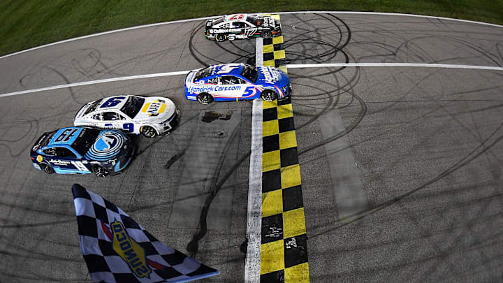 Kyle Larson won the May event at Kansas Speedway in a four-wide photo finish with Chris Buescher, Chase Elliott, and Martin Truex, Jr. Kyle Larson won the May event at Kansas Speedway in a four-wide photo finish with Chris Buescher, Chase Elliott, and Martin Truex, Jr.