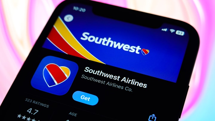 In this photo illustration, the Southwest Airlines logo is...