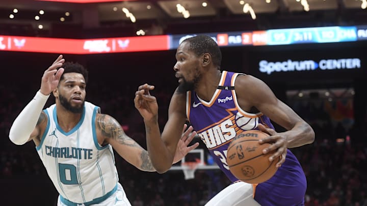 Jan 7, 2025; Charlotte, North Carolina, USA;  Phoenix Suns forward Kevin Durant (35) drives past Charlotte Hornets forward Miles Bridges (0) during the second half at the Spectrum Center. Mandatory Credit: Sam Sharpe-Imagn Images