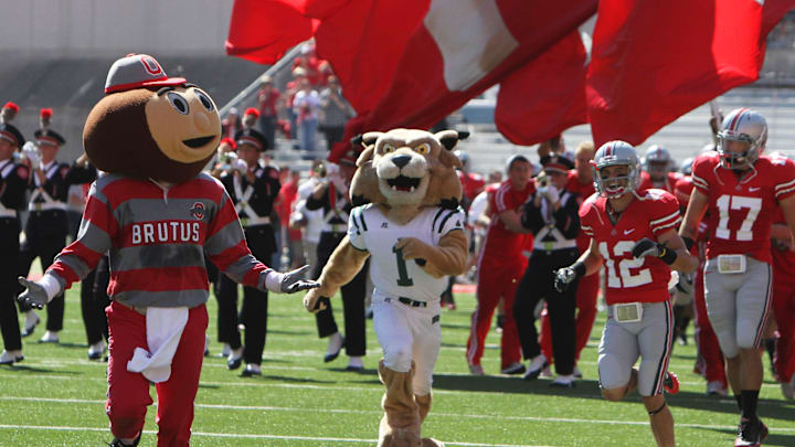 Ohio University Rufus mascot hits the ground after blindsiding Brutus Buckeye and a cheerleader as they made their way on to the field prior to the Ohio University NCAA football game at Ohio Stadium on September 18, 2010.