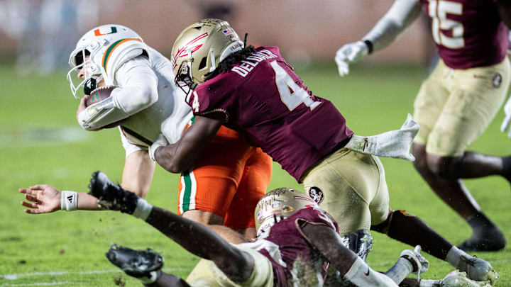 Florida State Seminoles linebacker Kalen DeLoach (4) tackles Miami Hurricanes quarterback Emory