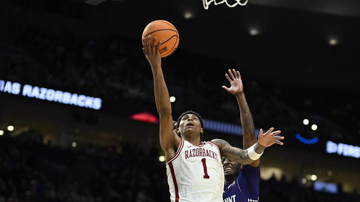 Mar 21, 2026; Portland, OR, USA; Arkansas Razorbacks guard Meleek Thomas (1) shoots against High Point Panthers forward Terry Anderson (5) in the second half during a second round game of the men's 2026 NCAA Tournament at Moda Center. Mandatory Credit: Troy Wayrynen-Imagn Images