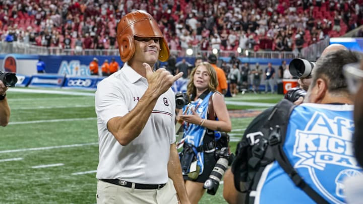 Aug 31, 2025; Atlanta, Georgia, USA; South Carolina Gamecocks head coach Shane Beamer wears the Old Leather Helmet after defeating the Virginia Tech Hokies at Mercedes-Benz Stadium. Mandatory Credit: Dale Zanine-Imagn Images