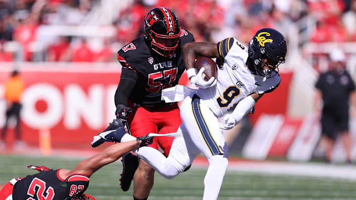Oct 14, 2023; Salt Lake City, Utah, USA; California Golden Bears wide receiver Taj Davis (9) runs the ball against Utah Utes safety Sione Vaki (28) and defensive tackle Keanu Tanuvasa (57) in the first quarter at Rice-Eccles Stadium. Mandatory Credit: Rob Gray-Imagn Images