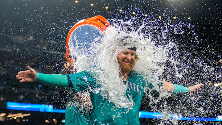 Sep 28, 2024; Seattle, Washington, USA; Seattle Mariners pinch hitter Justin Turner (2) is doused with water by centerfielder Julio Rodriguez (44) after a game against the Oakland Athletics at T-Mobile Park. Mandatory Credit: Stephen Brashear-Imagn Images