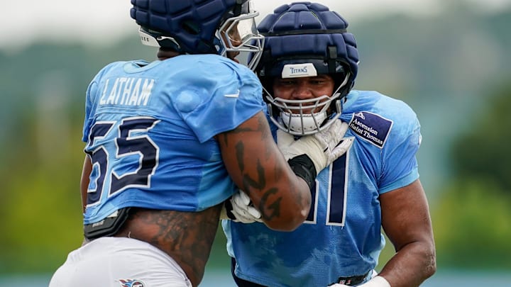 Tennessee Titans offensive tackle JC Latham (55) and offensive tackle John Ojukwu (61) run drills during an NFL football training camp practice at Ascension Saint Thomas Sports Park in Nashville, Tenn., Sunday, Aug. 3, 2025.