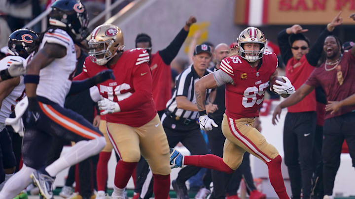 Dec 8, 2024; Santa Clara, California, USA; San Francisco 49ers tight end George Kittle (85) runs with the ball after making a catch against the Chicago Bears in the first quarter at Levi's Stadium. Mandatory Credit: Cary Edmondson-Imagn Images