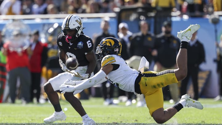 Dec 31, 2025; Tampa, FL, USA; Iowa Hawkeyes defensive back TJ Hall (2) breaks up a pass to Vanderbilt Commodores wide receiver Tre Richardson (6) in the second quarter during the ReliaQuest Bowl at Raymond James Stadium. Mandatory Credit: Nathan Ray Seebeck-Imagn Images Dec 31, 2025; Tampa, FL, USA; Iowa Hawkeyes defensive back TJ Hall (2) breaks up a pass to Vanderbilt Commodores wide receiver Tre Richardson (6) in the second quarter during the ReliaQuest Bowl at Raymond James Stadium. Mandatory Credit: Nathan Ray Seebeck-Imagn Images