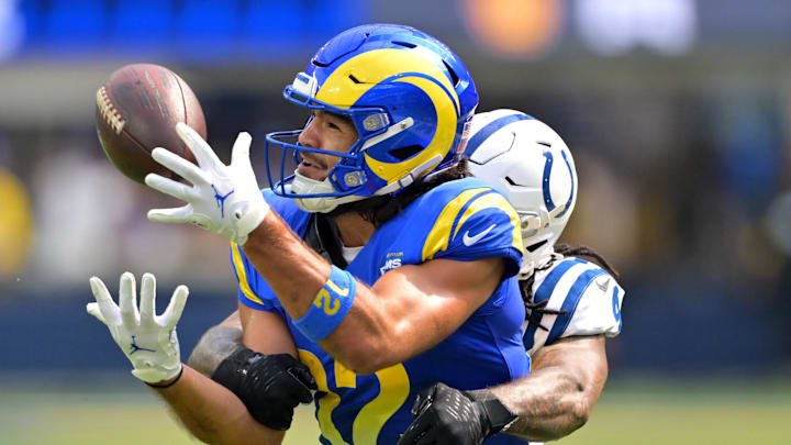 Los Angeles Rams wide receiver Puka Nacua (12) is stopped by Indianapolis Colts cornerback Xavien Howard (4) after a 31-yard pass reception in the first half at SoFi Stadium.