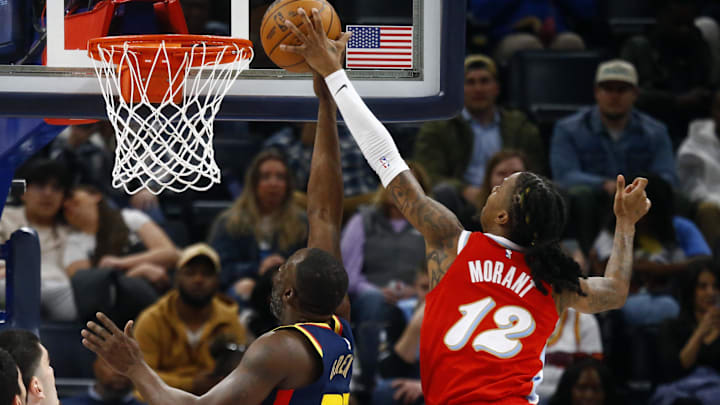 Dec 19, 2024; Memphis, Tennessee, USA; Memphis Grizzlies guard Ja Morant (12) blocks the shot attempt by Golden State Warriors forward Draymond Green (23) during the second quarter at FedExForum. Mandatory Credit: Petre Thomas-Imagn Images