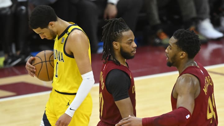 Apr 12, 2024; Cleveland, Ohio, USA; Indiana Pacers guard Tyrese Haliburton (0) and Cleveland Cavaliers guard Donovan Mitchell (45) react after a three-point basket by guard Darius Garland (10) in the fourth quarter at Rocket Mortgage FieldHouse. Mandatory Credit: David Richard-Imagn Images