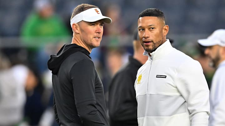 Oct 14, 2023; South Bend, Indiana, USA; USC Trojans head coach Lincoln Riley and Notre Dame Fighting Irish head coach Marcus Freeman chat before the game at Notre Dame Stadium. Oct 14, 2023; South Bend, Indiana, USA; USC Trojans head coach Lincoln Riley and Notre Dame Fighting Irish head coach Marcus Freeman chat before the game at Notre Dame Stadium.