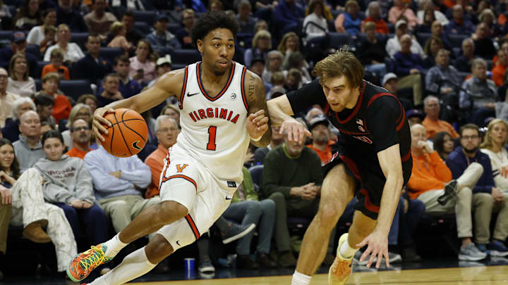 Jan 10, 2026; Charlottesville, Virginia, USA; Virginia Cavaliers guard Malik Thomas (1) drives to the basket past Stanford Cardinal forward Cameron Grant (20) in the second half at John Paul Jones Arena. Mandatory Credit: Geoff Burke-Imagn Images