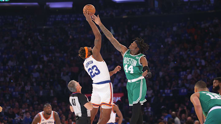 Oct 20, 2021; New York, New York, USA; New York Knicks center Mitchell Robinson (23) wins the opening tip off against Boston Celtics center Robert Williams III (44) during the first quarter at Madison Square Garden. Mandatory Credit: Brad Penner-Imagn Images