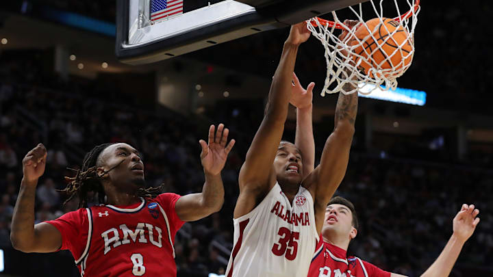 Alabama Crimson Tide forward Derrion Reid (35) throws down a dunk between Robert Morris Colonials guard Kam Woods (8) and Robert Morris Colonials forward Alvaro Folgueiras (7) during the second half of an NCAA Tournament First Round game at Rocket Arena on Friday, March 21, 2025, in Cleveland, Ohio. Alabama Crimson Tide forward Derrion Reid (35) throws down a dunk between Robert Morris Colonials guard Kam Woods (8) and Robert Morris Colonials forward Alvaro Folgueiras (7) during the second half of an NCAA Tournament First Round game at Rocket Arena on Friday, March 21, 2025, in Cleveland, Ohio.