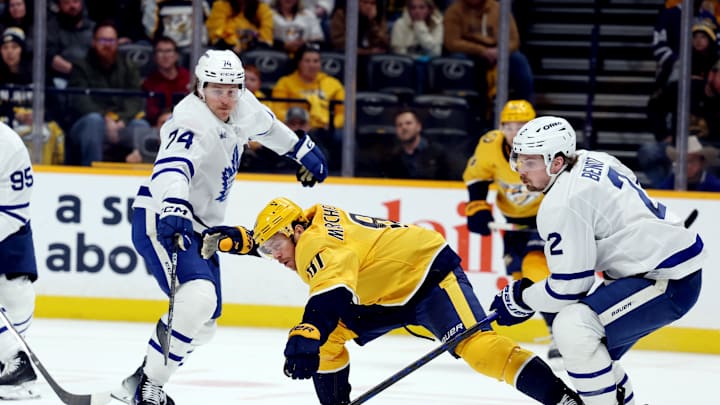 Mar 22, 2025; Nashville, Tennessee, USA; Nashville Predators center Jonathan Marchessault (81) has his stick knocked out of his hands while defended by Toronto Maple Leafs center Bobby McMann (74) and Toronto Maple Leafs defenseman Simon Benoit (2) during the third period of the game at Bridgestone Arena. Mandatory Credit: Alan Poizner-Imagn Images