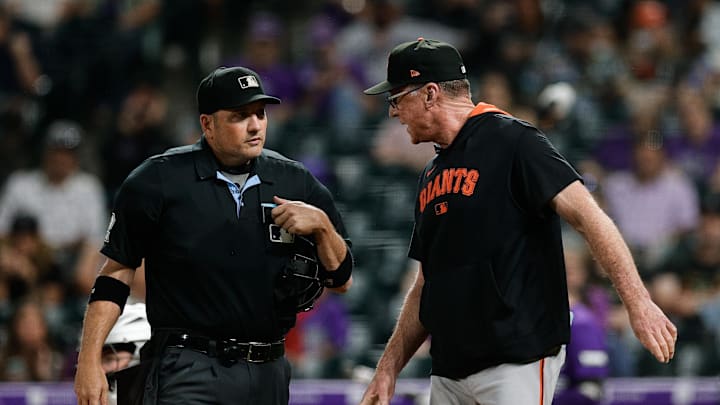 Sep 3, 2025; Denver, Colorado, USA; San Francisco Giants manager Bob Melvin (6) talks with home plate umpire Dan Bellino (2) in the fifth inning against the Colorado Rockies at Coors Field. Mandatory Credit: Isaiah J. Downing-Imagn Images
